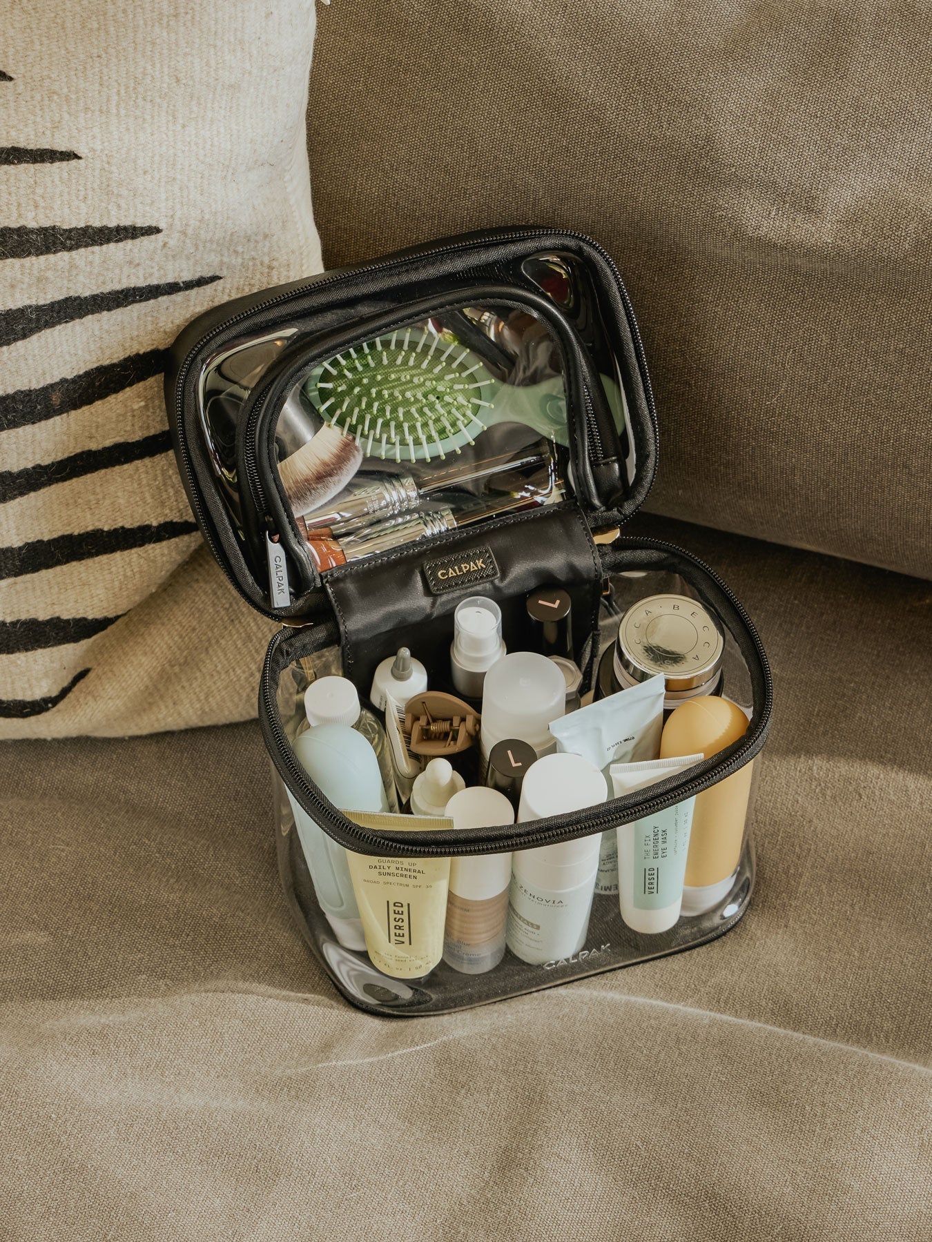 CLEAR-TRAIN-CASE-WITH-TOP-COMPARTMENT-BLACK-LIFESTYLE1_fa39ea9e-2608-4133-8359-649ce69ce96f.jpg