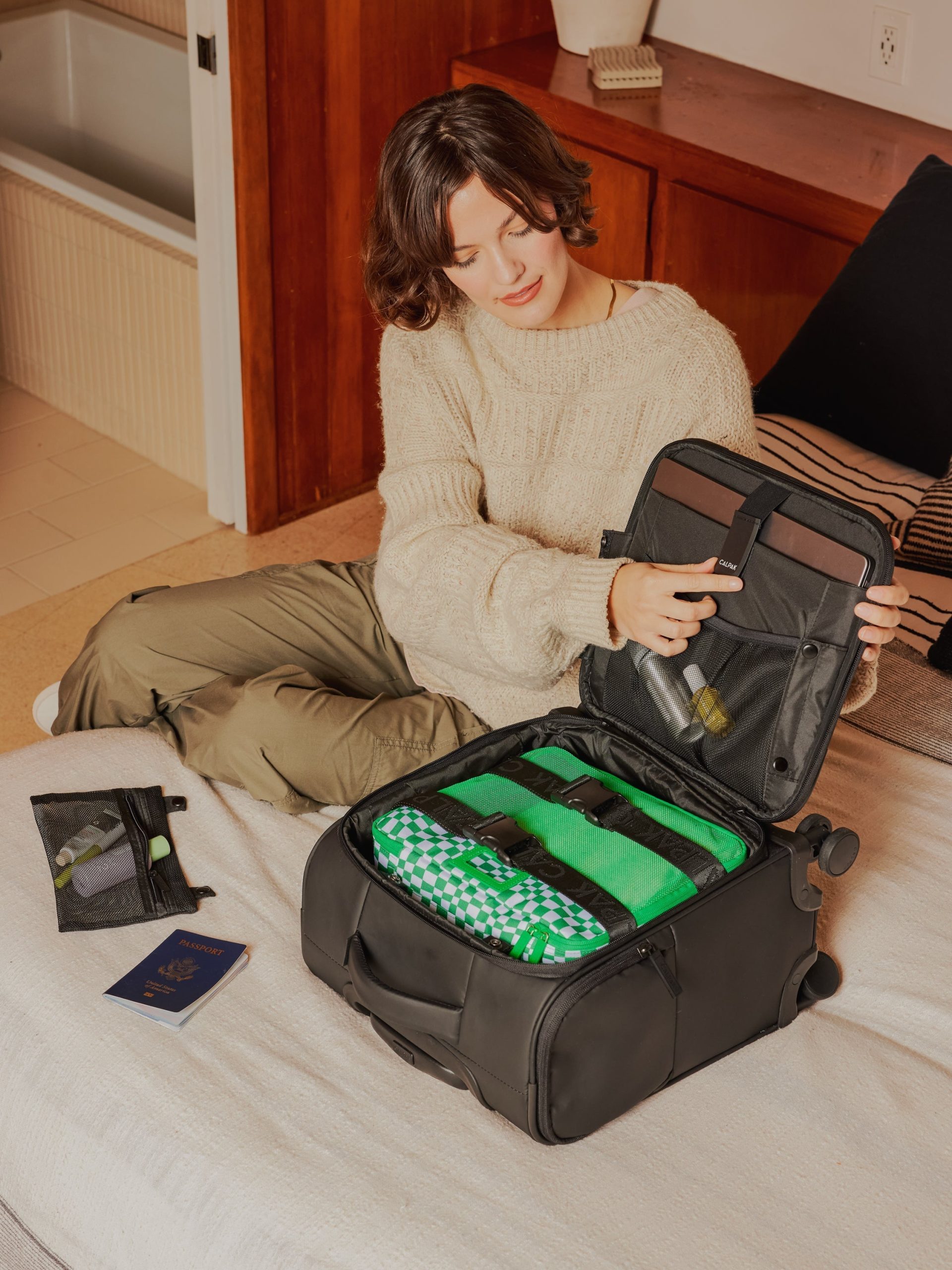LUKA-MINI-CARRY-ON-LUGGAGE-BLACK-LIFESTYLE1_1edbcae6-e56f-426c-ae18-b468192bcb5e.jpg