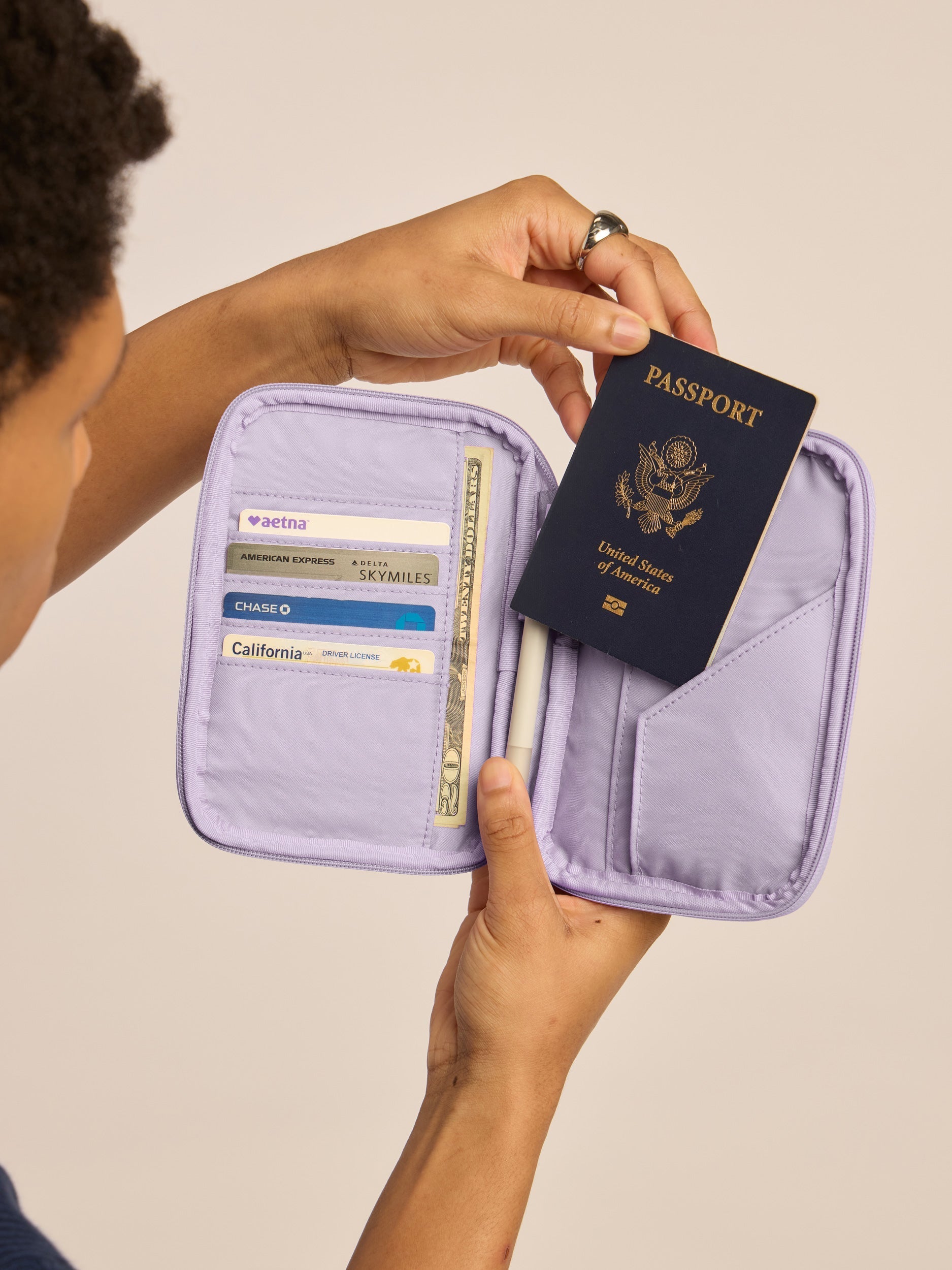 LUKA-ZIPPERED-PASSPORT-WALLET-ORCHID-PZW2301-LIFESTYLE1.jpg
